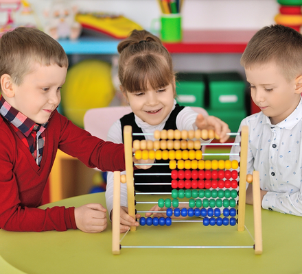 Children playing with an abacus together