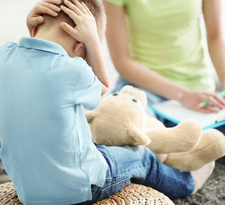 Therapist supporting a child during a difficult moment