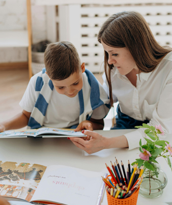 Adult and child reading a book together